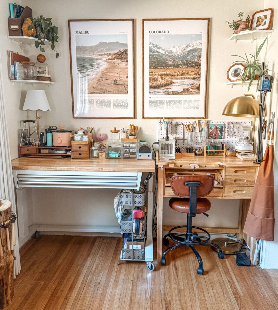 The Foreverie jewelry studio featuring a wooden bench, framed artwork, and organized silversmithing tools.