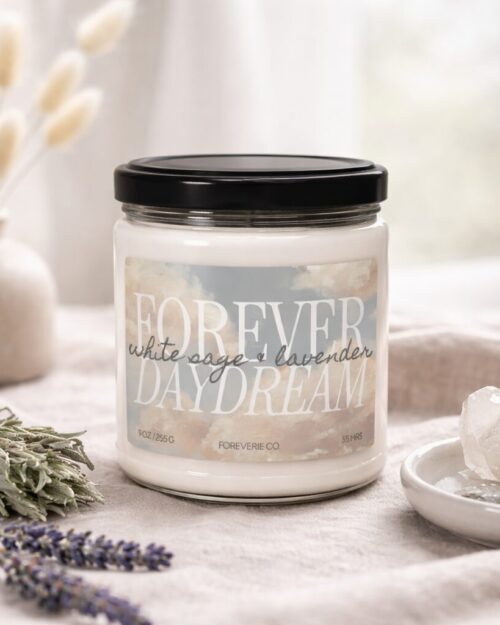 Forever Daydream soy candle by Foreverie styled on soft linen with lavender, sage, and crystal accents in a neutral, airy setting.
