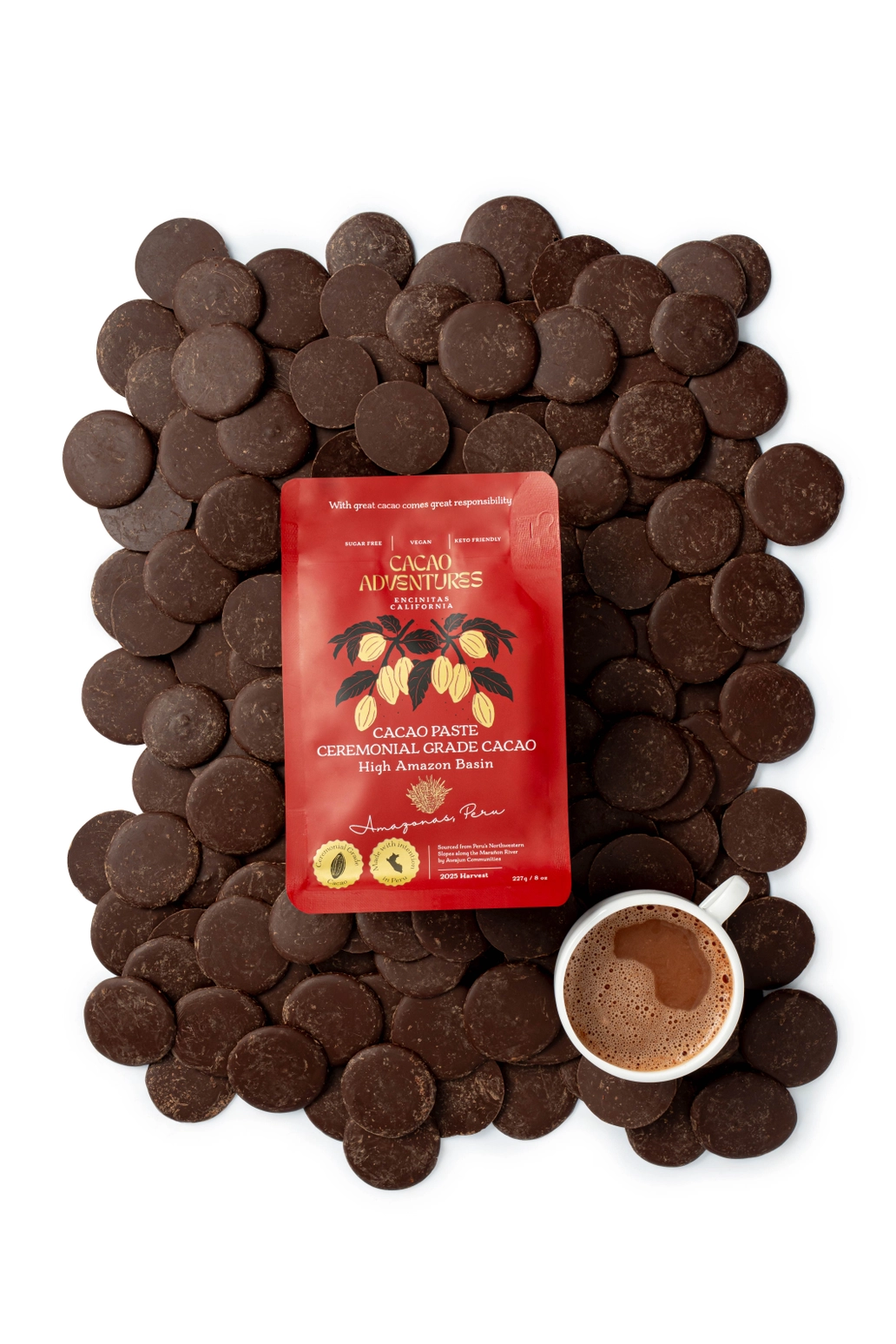 Ceremonial cacao drink in mug surrounded by cacao paste discs
