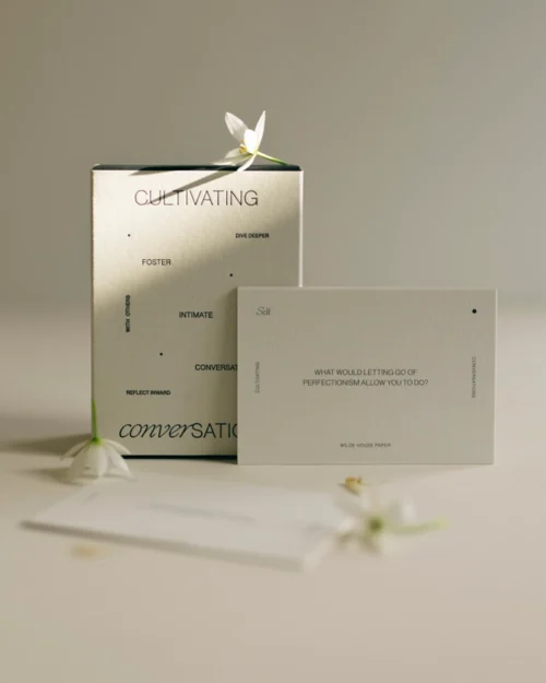 Cultivating Conversations card deck styled with stacked prompt cards in a soft neutral setting.