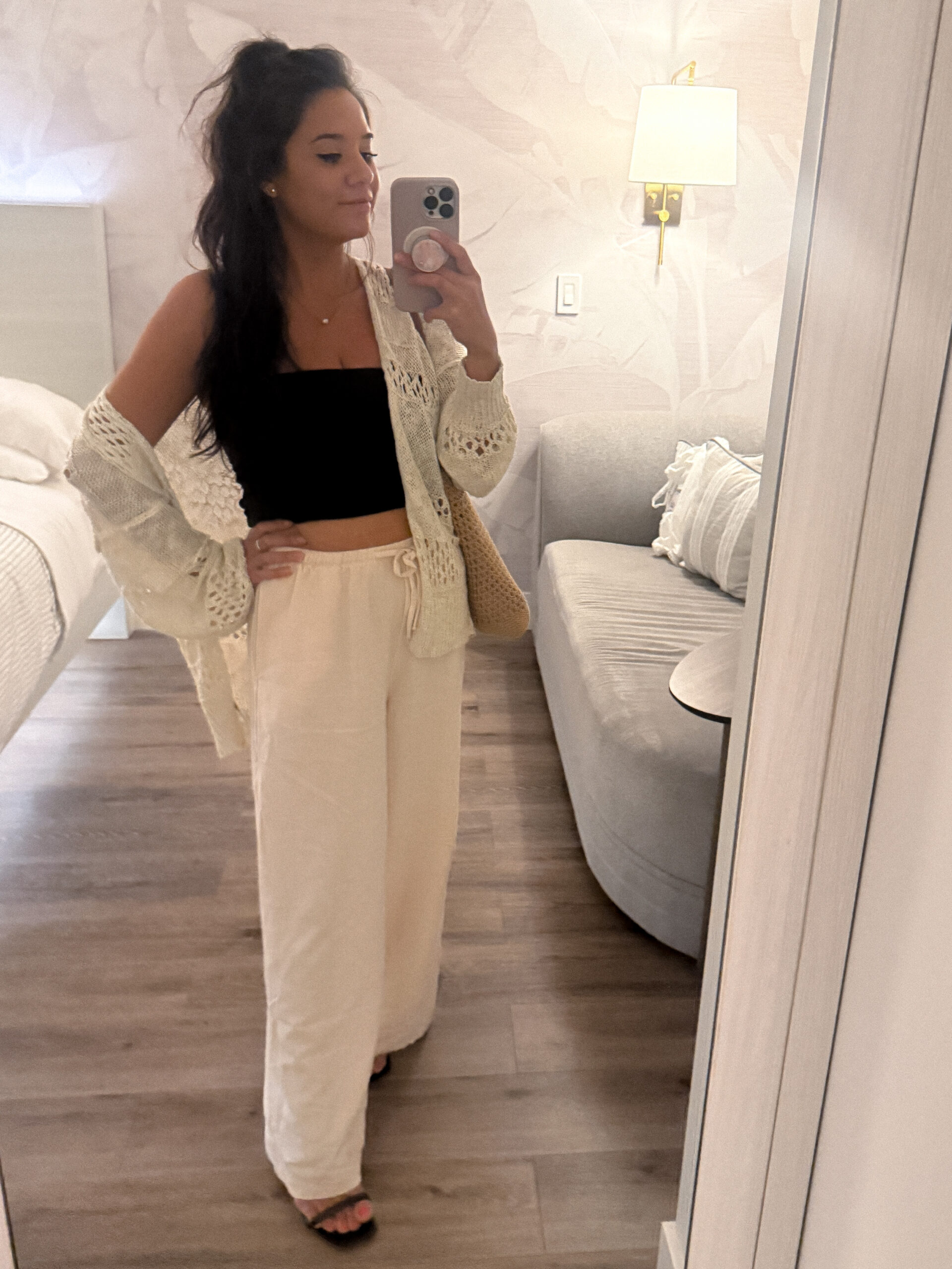 Kayla wearing neutral loungewear outfit taking a mirror selfie