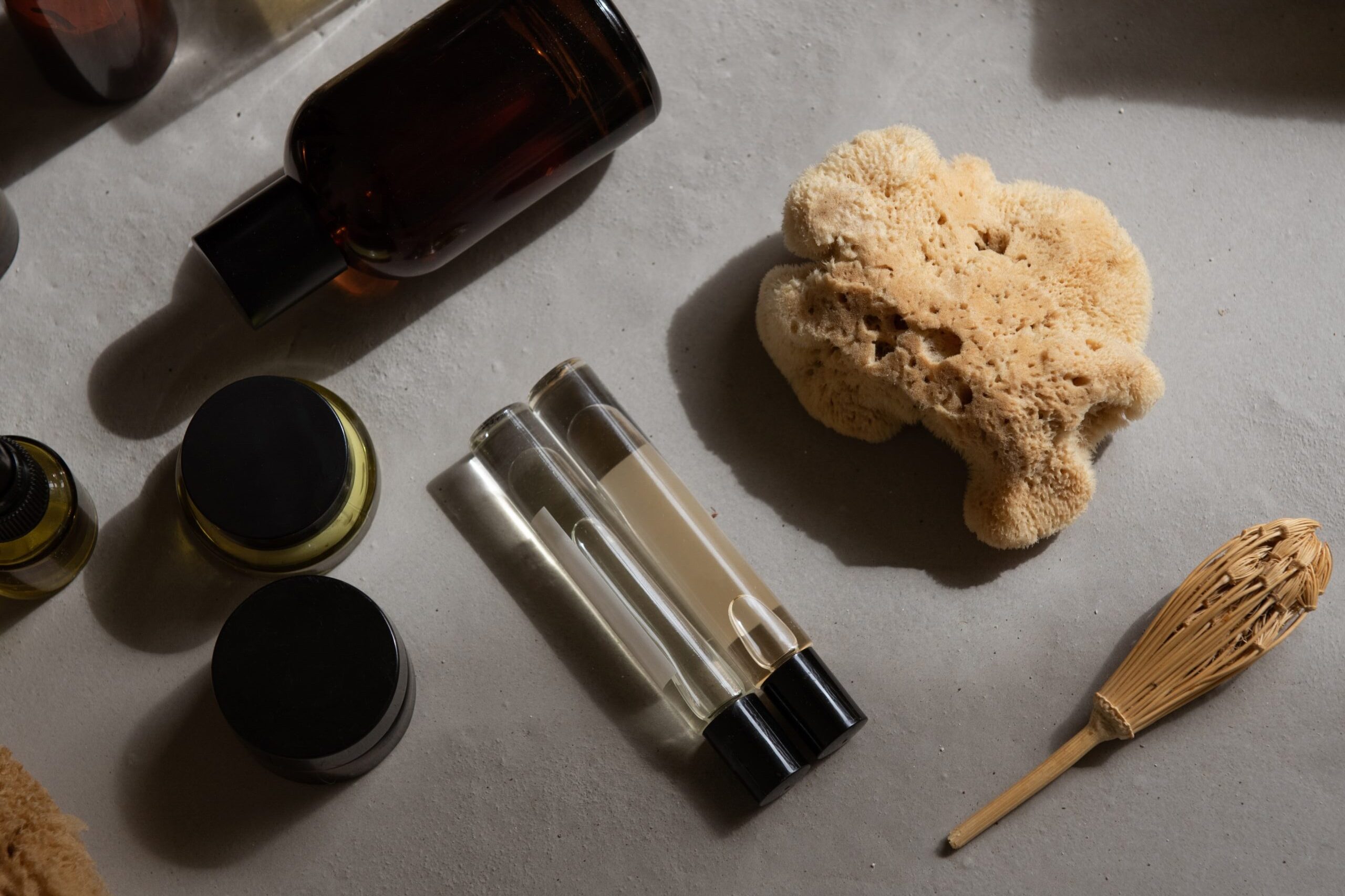 Minimal skincare products styled with natural beauty tools in warm sunlight.