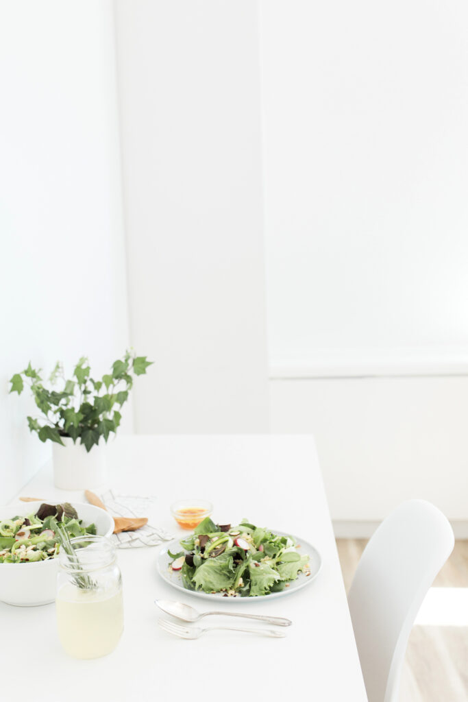 Fresh green salad served on a bright minimalist dining table